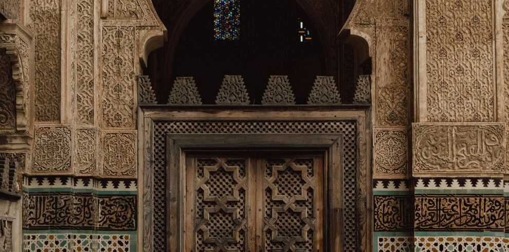 Beautiful Moroccan door with traditional Islamic patterns and mosaic tiles in Fes, Morocco.