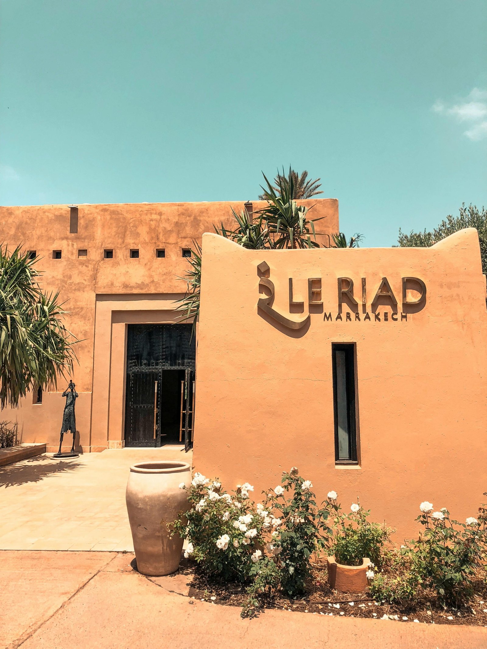 Explore the stunning architecture of Le Riad in Marrakech, Morocco, surrounded by desert-inspired landscape.
