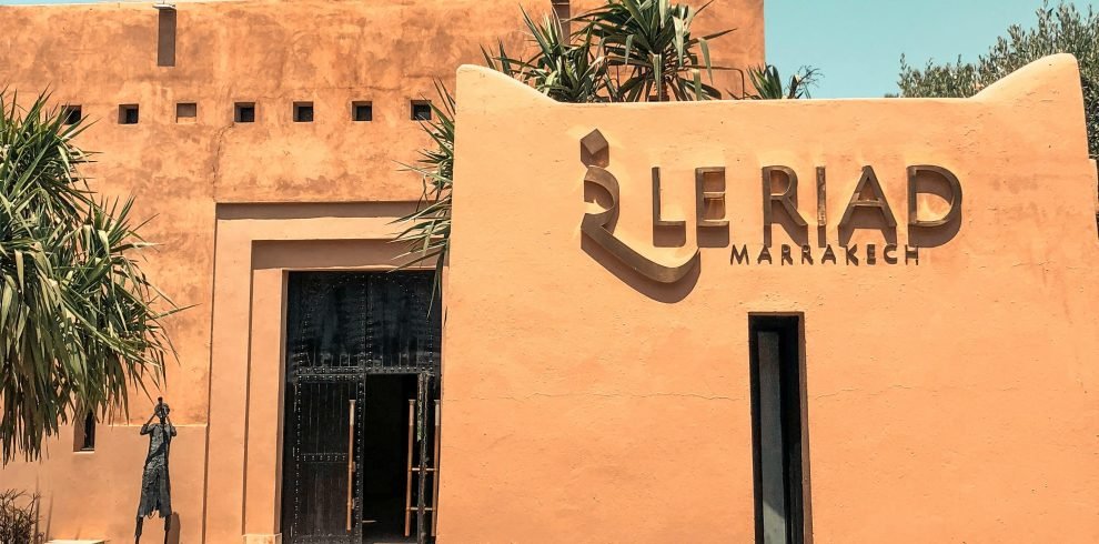 Explore the stunning architecture of Le Riad in Marrakech, Morocco, surrounded by desert-inspired landscape.