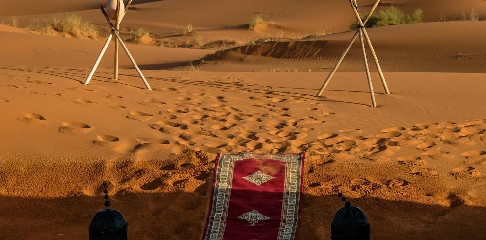 Explore the stunning sunset in Merzouga, Morocco with a vibrant pathway through the dunes.